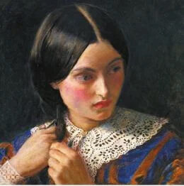 A young girl with a stone-serious face, looking away as she is braiding her hair.