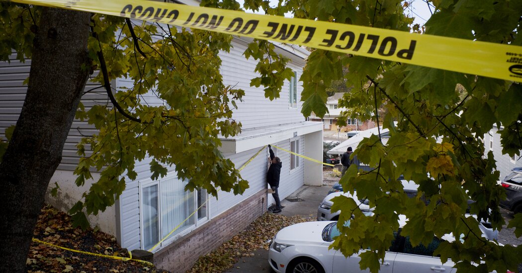 Photograph of the University of Idaho murder scene with one police officer and yellow police tape.
