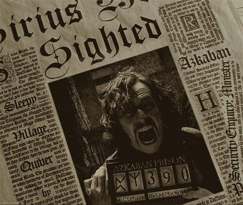 Photo of a newspaper with a photo of Sirius Black holding his prison number. His mouth is wide open as if he is screaming. He has a look of terror on his face. 