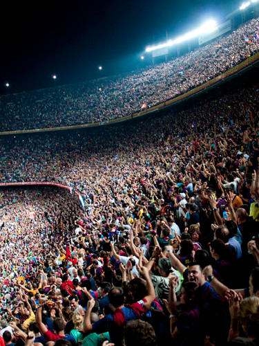 Fans cheering in a football stadium