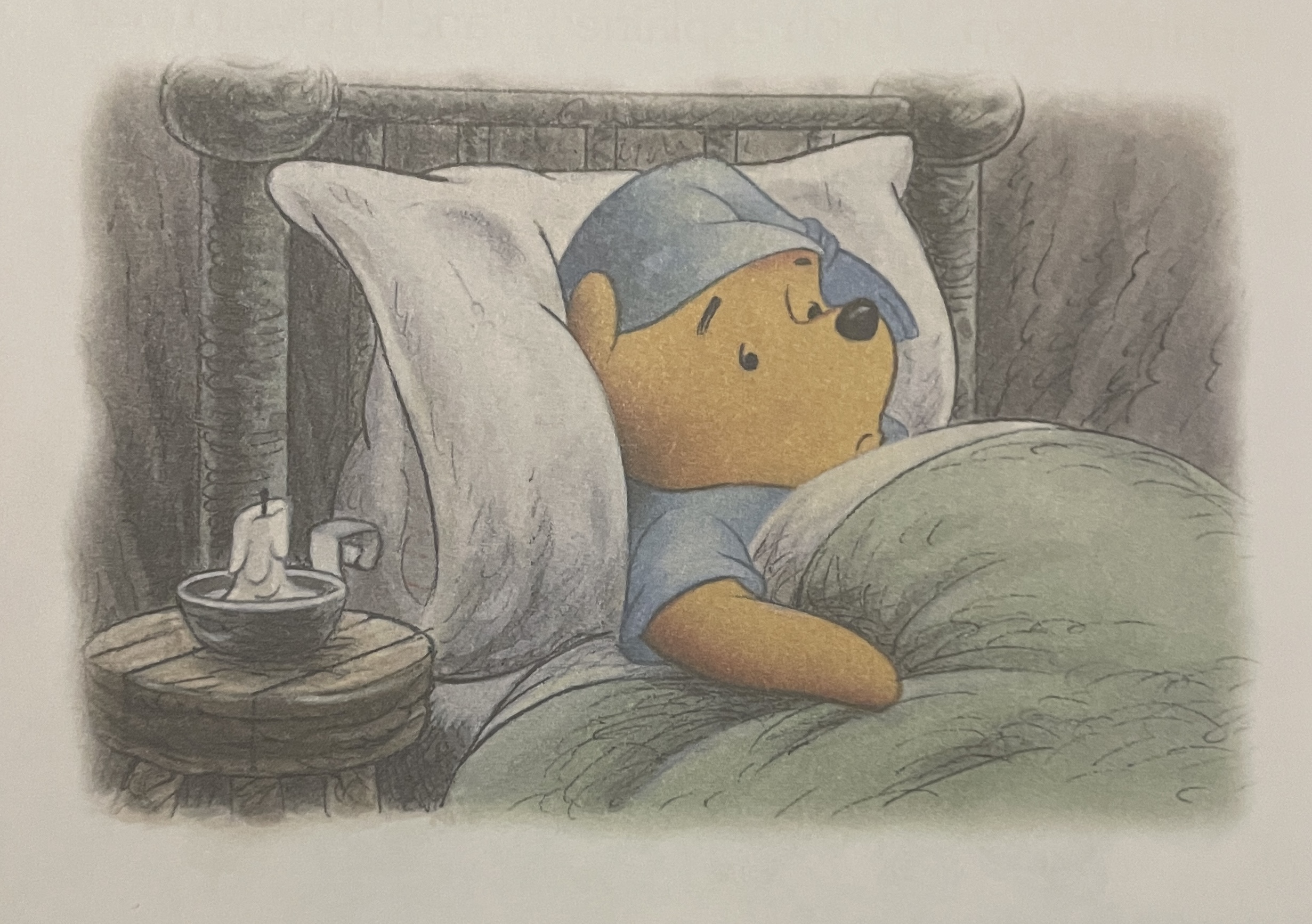 A drawing of Winnie the Pooh in bed with blue pajamas and a green blanket. Pooh looks somber, his eyes are open and both his mouth and eyebrows are curved downward in frowns. Next to Pooh is an unlit white candle.